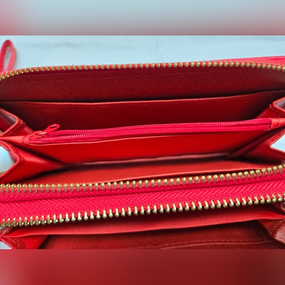 Red wallet with 2 zipper compartments and a wrist handle. - Picture 7 of 12
